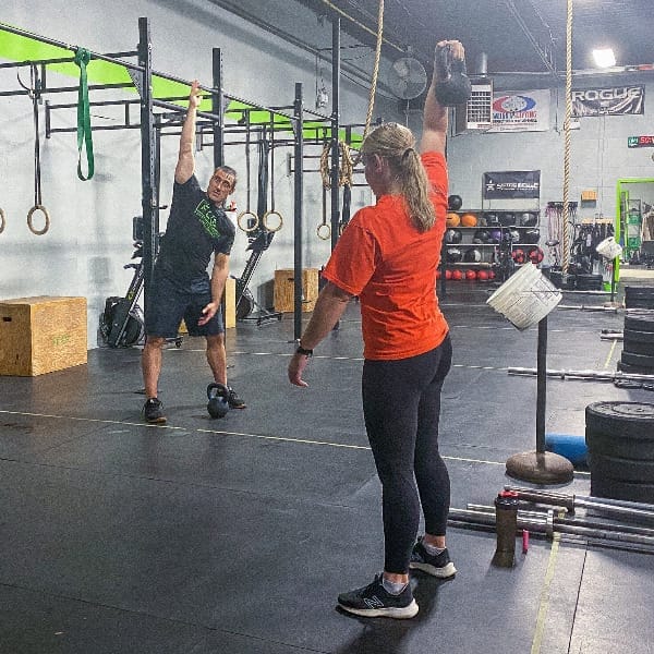 female CrossFit athlete receiving personal training from male CrossFit coach in London Ontario